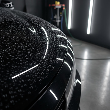 Ceramic coating beading water on a hood