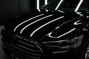 Hood reflection with parallel stripe lights showing uniform gloss