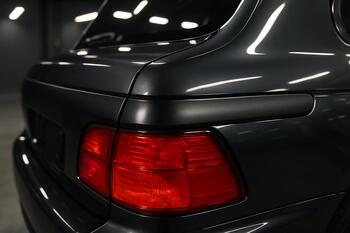 Restored dark trim with protective top coat